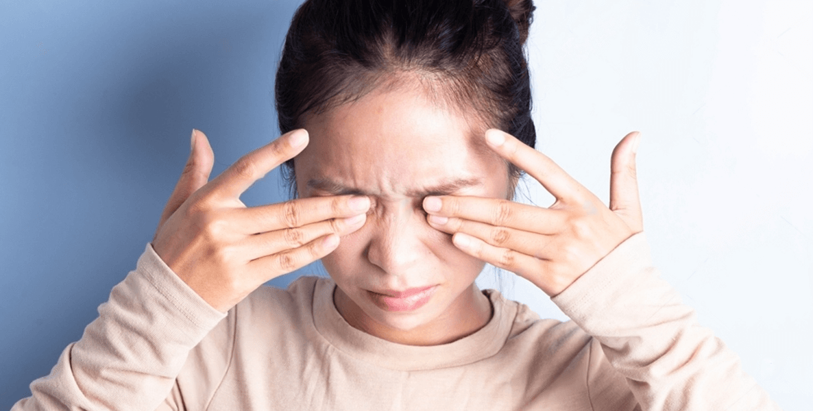 Woman rubbing her eyes from conjunctivitis