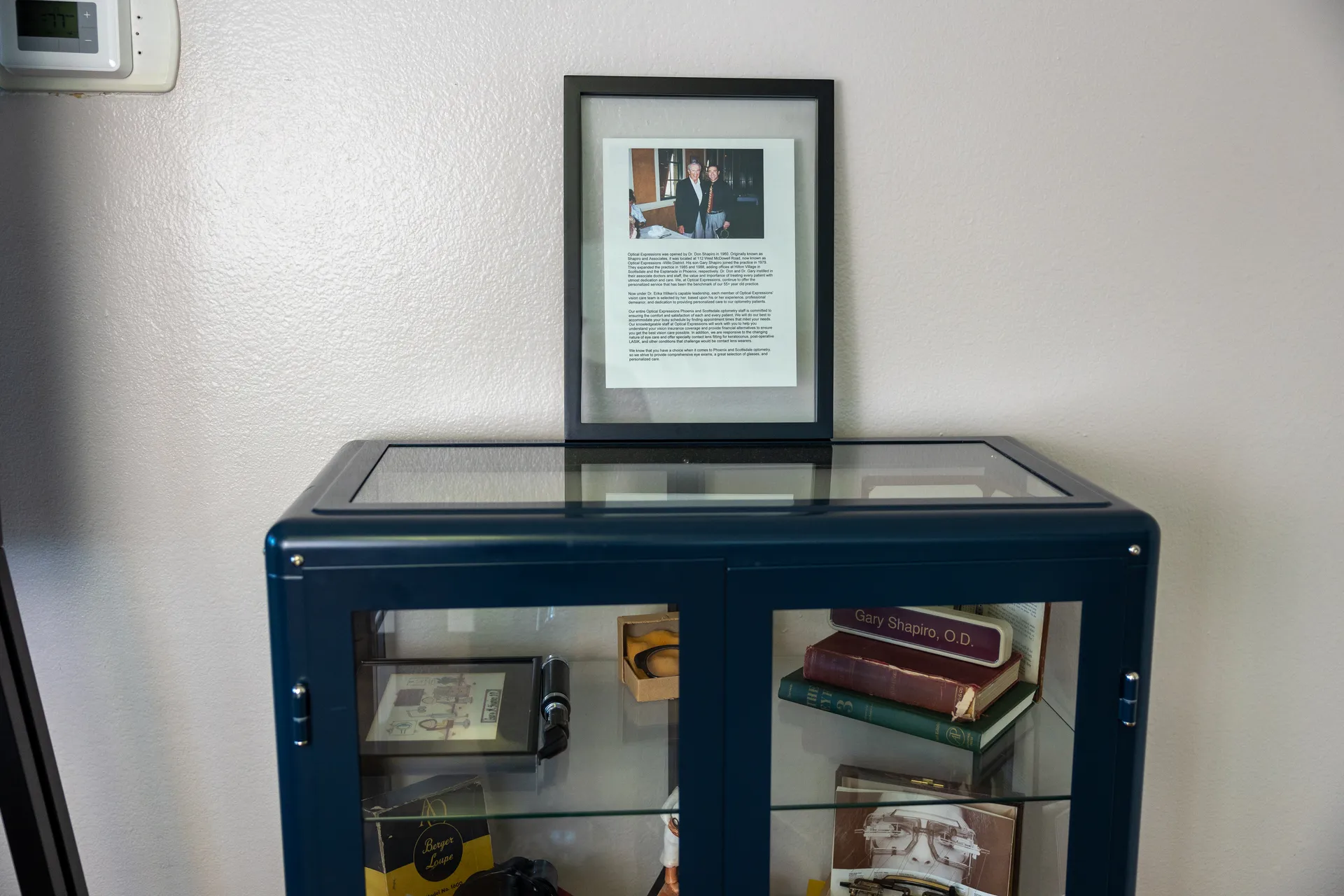 display case with books and framed documents