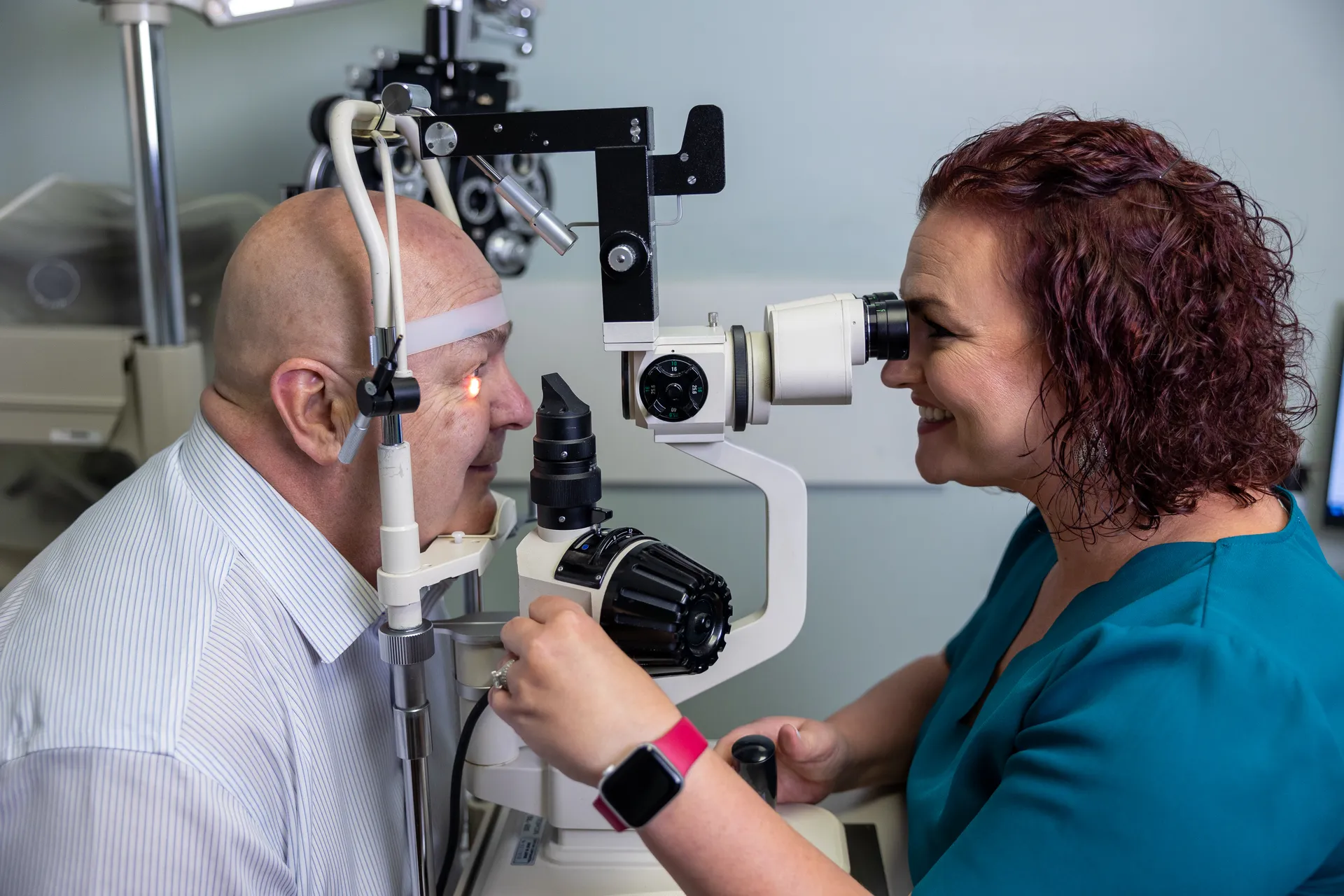 optometrist examining a man's eye