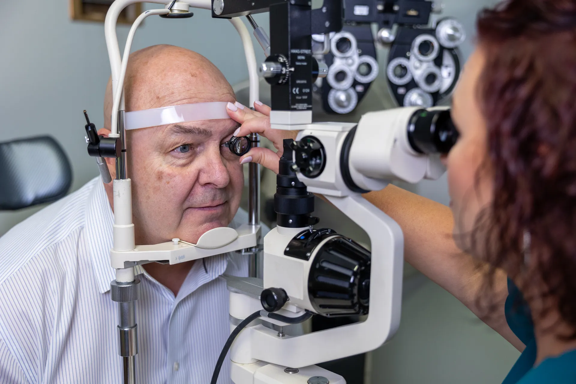 optometrist examining a man's eye